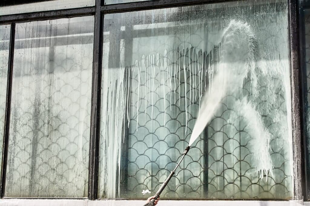 A,Window,Is,Being,Cleaned,With,A,Pressure,Washer., window cleaning services